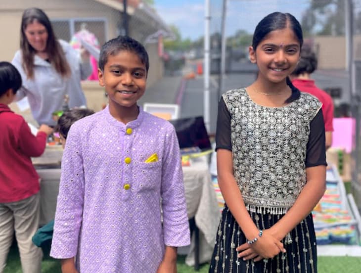 Two students dressed in traditional attire smiling on Multicultural Day