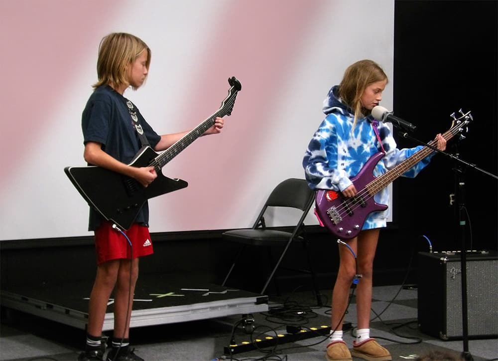 Two students playing guitar and bass at the Spring Talent Show