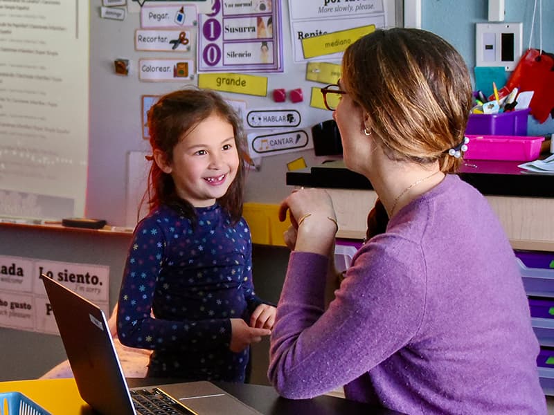 A student and teacher practicing Spanish together