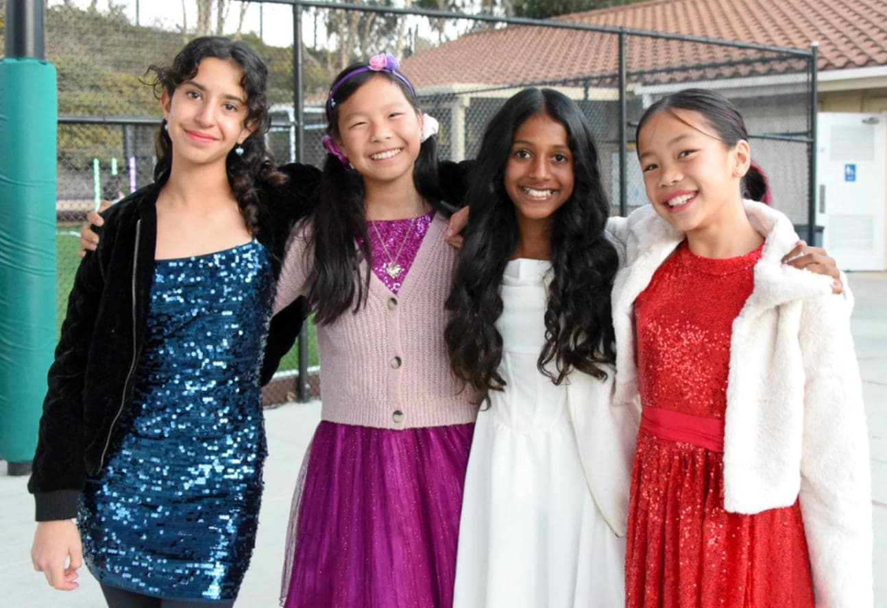 A group of students dressed up and smiling together outdoors