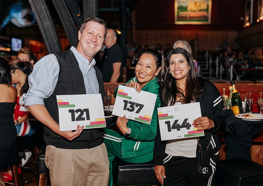 Guests holding bid number cards at the Foundation gala