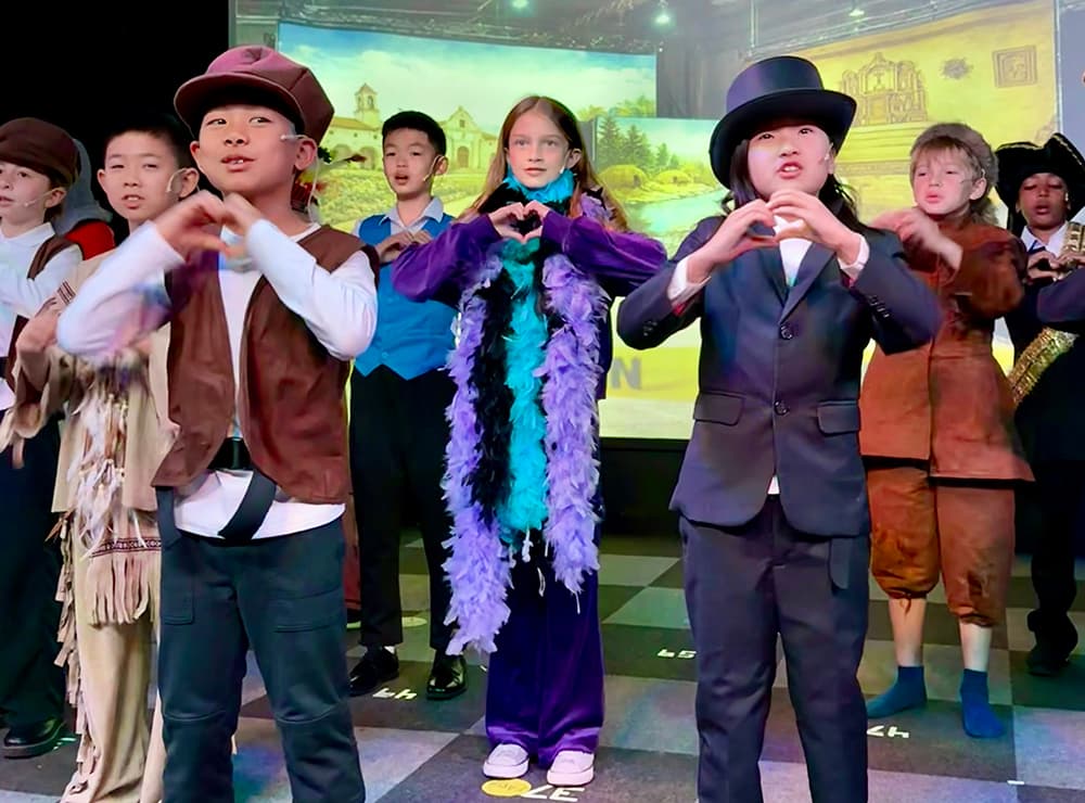 Students performing on stage in costume