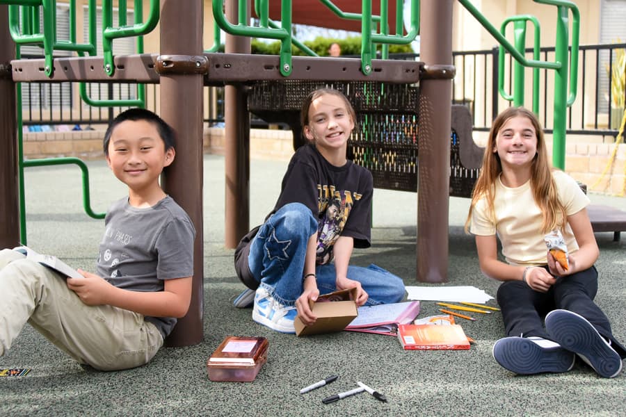 Students reading together on the playground