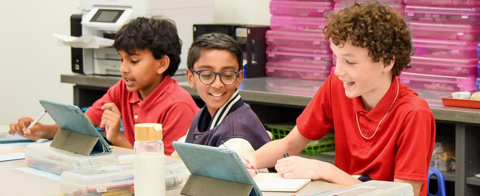 Sixth graders working on tablets in the classroom