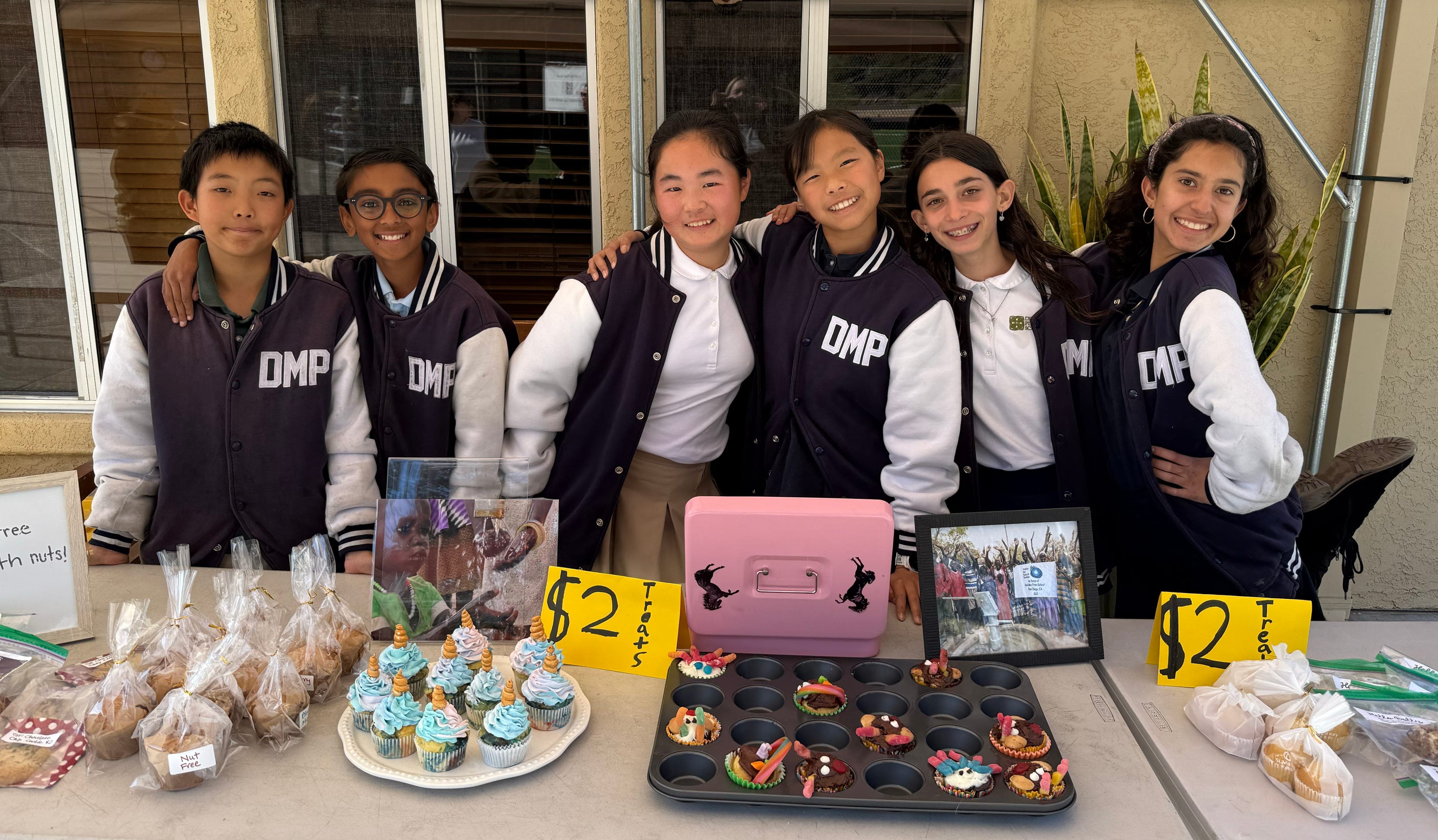 Sixth graders running a bake sale to raise money for a clean-water project