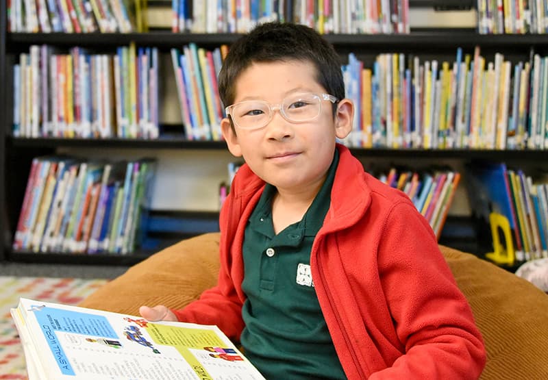 A Del Mar Pines student reading in the school library
