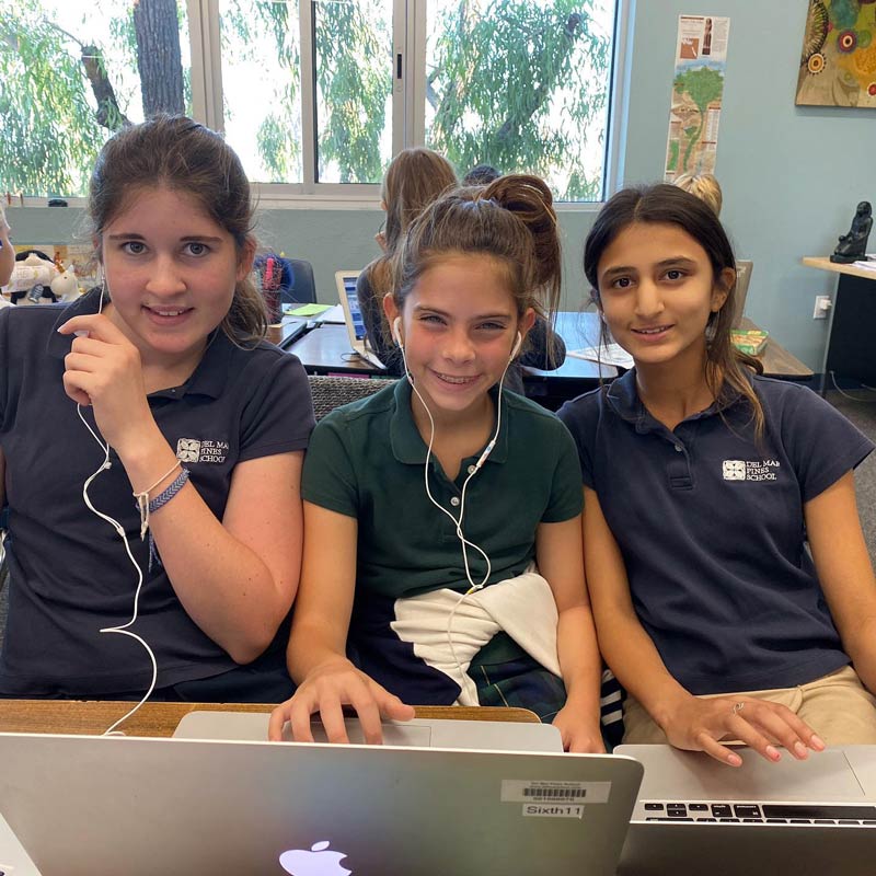 3 del mar pines students in front of a laptop