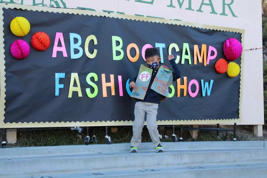 A DMP student participates at a bootcamp fashion show